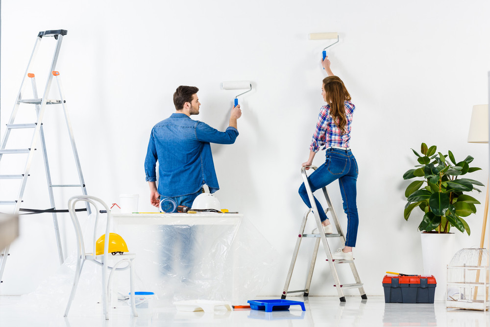 couple painting their house